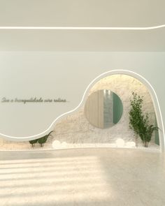 the interior of a building with white walls and green plants