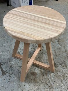 a wooden table sitting on top of a cement floor