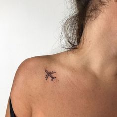 a woman with a small tattoo on her shoulder