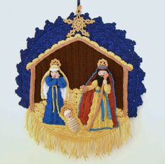 a crocheted nativity ornament hanging on a wall