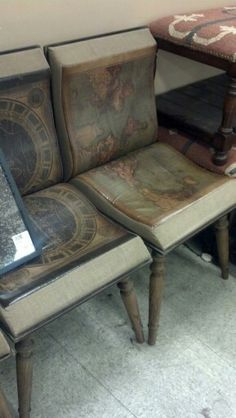 two chairs and a table are sitting next to each other in a room with carpet on the floor