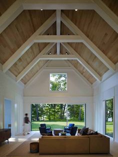 a living room filled with furniture and a circular light hanging from the ceiling above it