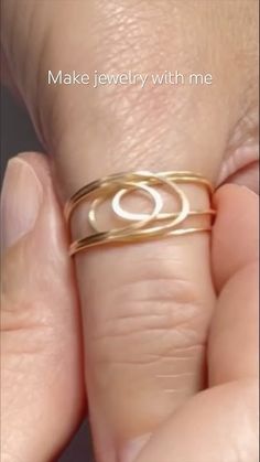 someone is holding their gold ring with the letter o on it