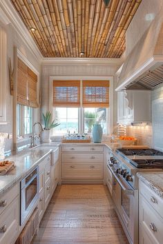 a kitchen with white cabinets and wooden ceilinging, along with bamboo shades on the windows