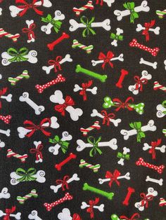 a black background with red, green and white bows and bones