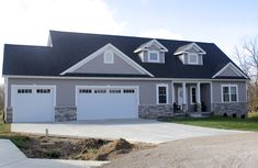 a house with two garages on the front and one attached to the back of it