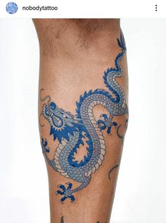 a man's leg with a blue dragon tattoo on it