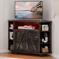 a flat screen tv sitting on top of a wooden cabinet