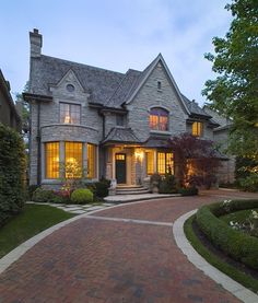 a large brick driveway leading to a house