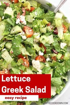 lettuce greek salad with feta cheese and tomatoes in a large white bowl