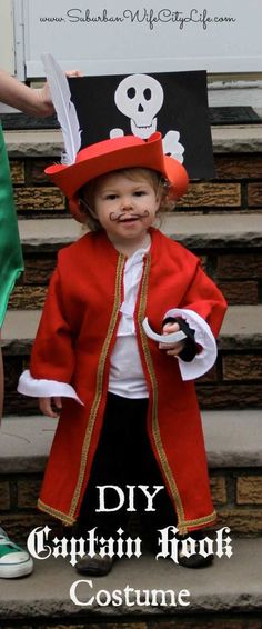 a little boy in a pirate costume standing on some steps