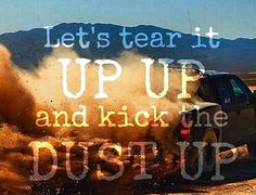 a truck is driving through the dirt with words on it that read, let's tear it up and kick the dust up