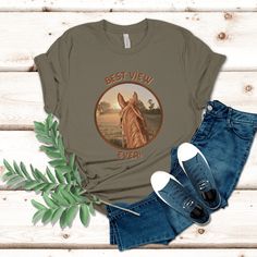 Introducing the perfect gift for horse girls Our Horseback Riding T-shirt is designed for those who are crazy about horses. This comfortable crew neck shirt is perfect for horseback riding and showcases your love for these majestic animals. The shirt comes in a unique and stylish cowgirl" design that's perfect for boho western fashion. Give the gift of comfort and style with this unique Horse Lover Shirt, perfect for any occasion. Get your Horse Shirt today! Cowgirl Design, Horse Shirt, Horse T Shirts, Best View, Long Cut, Majestic Animals, Horse Girl, Crew Neck Shirt, Horseback Riding