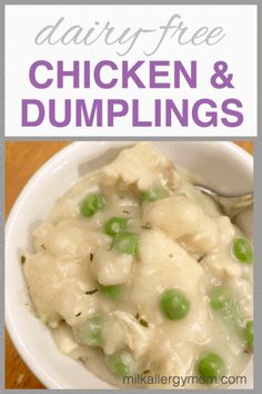 a white bowl filled with chicken and dumplings on top of a wooden table next to a