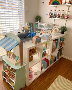 a child's playroom with shelves and toys