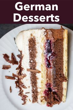 a piece of german desserts on a white plate with chocolate shavings and cherries