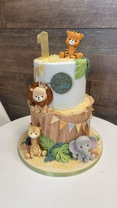 a three tiered cake with animals on it