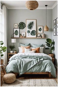 a bedroom with plants and pictures on the wall above the bed, along with a wicker basket