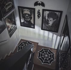 the stairs are decorated with black and white halloween decorations, including spider - webs