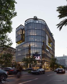 a large glass building sitting on the side of a road