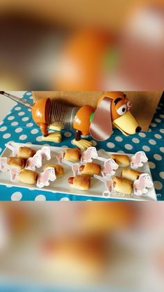 some food is on a blue and white tablecloth with polka dots, including hotdogs