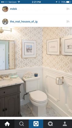 a white toilet sitting next to a sink in a bathroom under a mirror on top of a wooden cabinet