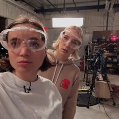 two women wearing protective goggles in a factory