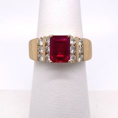 KARAT GOLD: 14K YELLOW GOLD  STYLE: GEMSTONE + DIAMOND  CONTAINS: (1) EMERALD CUT CHATHAM LAB CREATED RUBY (12) NATURAL ROUND DIAMONDS  GEMSTONE WEIGHT/MEASUREMENTS: APPROXIMATE 8X6MM 1.50ct DIAMOND WEIGHT/MEASUREMENTS: APPROXIMATE 1.00CT  CLARITY: SI2 (DIAMONDS)  COLOR: H TOP OF RING MEASURES: 8MM FINGER SIZE: 6 GRAM WEIGHT: 9.9  ALL WEIGHTS ARE APPROXIMATE Ladies Ring, Ruby Diamond, Diamond Gemstone, Gold Style, Emerald Cut, Lab Grown, Colored Diamonds, Women Rings, Round Diamonds