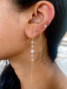 Pearls have been highly prized for all of history - it's said that Krishna plucked the first pearl from the ocean for his daughter to wear on her wedding. These pearls check all the boxes. They're modern, minimalist, classic, but also so beautiful that they'll take your breath away. These earrings are available in two styles - the standard extra long threader, and the double terminated threader. The standard threader has one end totally open and dangling, the other end threading through one or m Elegant Earrings With Satellite Chain As Gift, Elegant Earrings With Satellite Chain For Gift, Classic Dangle Jewelry With Pearl Chain, Wedding Pearl Chain Earrings In Yellow Gold, Timeless Wedding Pearl Earrings With Pearl Chain, Wedding Yellow Gold Pearl Chain Earrings, Minimalist Pearl Earrings With Pearl Chain For Anniversary, Minimalist Pearl Chain Earrings For Anniversary, White Pearl Threader Earrings With Charm