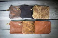 "Handcrafted from our American Cowhide Leather, we've created a smaller version of our Leather Valuables Pouch to hold your tees and golf balls!  The solid brass trigger hook easily connects to your golf bag.  Inside is lined with houndstooth fabric  8\"x 6\" Choose your Leather and FREE personalization on the leather! -Check out the smaller size vs. the larger size Due to the handcrafted nature of our products, please allow time for order fulfillment. International shipping rates not exceeding Brown Pouch With Cell Phone Pocket For Everyday Carry, Everyday Carry Pouch With Coin Pocket, Brown Pouch With Coin Pocket For Everyday Carry, Brown Pouch With Zipper Pocket As Gift, Brown Pouch With Zipper Pocket For Gift, Gift Brown Pouch With Zipper Pocket, Brown Pouch For Everyday Use, Brown Waxed Finish Pouch For Everyday Use, Tee Bag