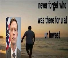 a man in a suit and tie walking on the beach next to an american flag