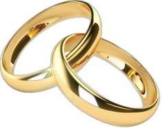 two gold wedding rings sitting next to each other