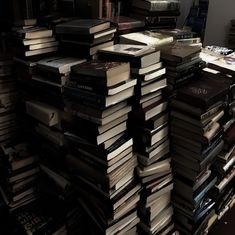 a large stack of books sitting on top of a table