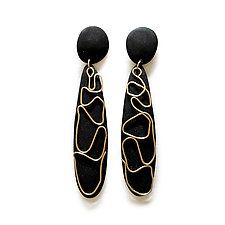 two black and gold earrings on white background