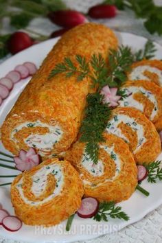 some food is laying out on a white plate with green garnish and sprigs