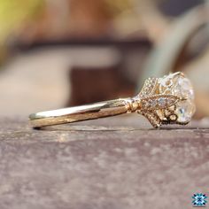 a diamond ring sitting on top of a wooden table