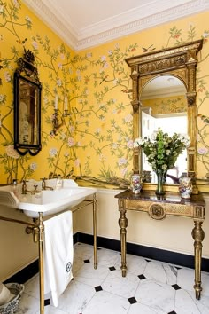 a bathroom with yellow walls and floral wallpaper in the bathtub, sink and mirror