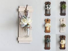 several vases with flowers are hanging on the wall next to wooden plaques and lights