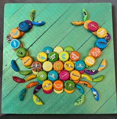 a crab made out of buttons sitting on top of a wooden table