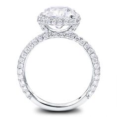 a diamond engagement ring with two rows of diamonds on the band and an oval shaped center stone