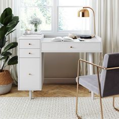 a white desk and chair in front of a window with a potted plant next to it