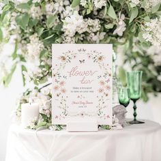 a white table topped with flowers and candles