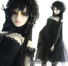 the doll is wearing a black dress with long sleeves and laces on it's head