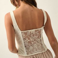 A solid, floral lace corset Scoop neckline Mesh floral lace panel bodice Low back with mesh floral lace panel Light boning Zipper on side with clasp True to size, fitted silhouette Model Info: Height: 5’ 9” | Bust: 34” | Waist: 26” | Hips: 37” | Wearing Size S. 100% Polyester Hand wash cold, hang to dry Introducing the Alicia Corset, a corset top featuring intricate floral lace detailing. The scoop neckline and sleeveless design, coupled with delicate mesh floral lace panels on the bodice, creat Panel Light, Lace Corset, Fitted Silhouette, Lace Panelled, Corset Top, Scoop Neckline, Jewelry Sales, Floral Lace, Jumpsuit Romper