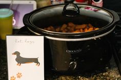 a crock pot with a card next to it