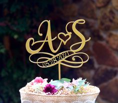 a wedding cake topper with the initials as ands on it