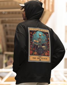 The Drummer Tarot Card Hoodie, Unisex Hooded Sweatshirt for Drum Player Gift, Drummer Hoodie Made with a thick blend of cotton and polyester, it feels plush, soft and warm, a perfect choice for any cold day. In the front, the spacious kangaroo pocket adds daily practicality while the hood's drawstring is the same color as the base sweater. .: Made with a medium-heavy fabric (8.0 oz/yd² (271 g/m that consists of 50% cotton and 50% polyester for that cozy feel and warmth you need in a hoodie. .: Classic fit along with the pouch pocket Winter Fan Merchandise Hoodie With Adjustable Hood, Winter Fan Merchandise Sweatshirt With Adjustable Hood, Band Merch Hoodie For Winter, Winter Band Merch Hoodie, Winter Band Merch Hooded Sweatshirt, Fleece Hooded Hoodie Fan Merchandise, Winter Hooded Band Merch Sweatshirt, Fleece Hooded Sweatshirt For Fan Merchandise, Fleece Hooded Sweatshirt For Fans