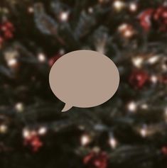 a brown speech bubble sitting on top of a christmas tree