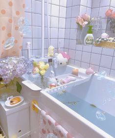 a bathroom with pink and yellow flowers in the bathtub