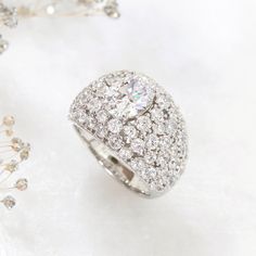 a diamond ring sitting on top of a white surface